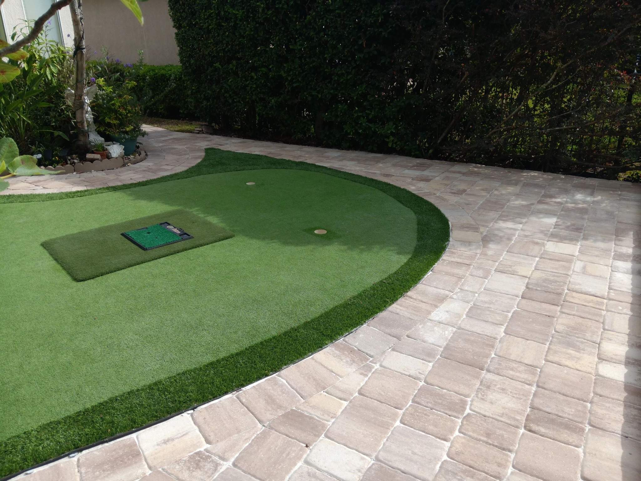 Custom putting green with paver patio